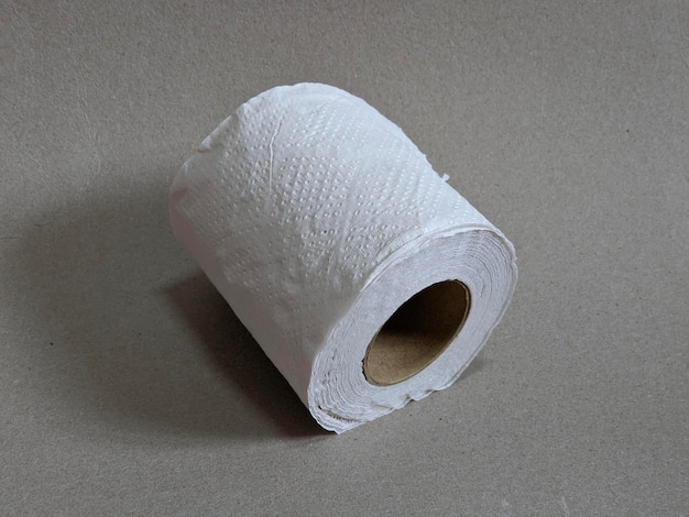 A roll of toilet paper on grey background