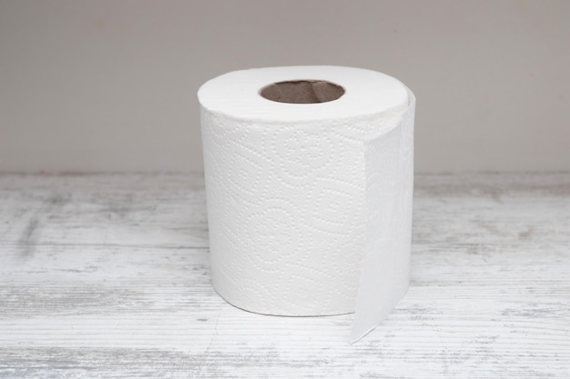 A roll of toilet paper on a white table.