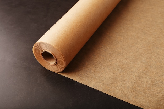 A roll of unfolded brown parchment paper, for baking food