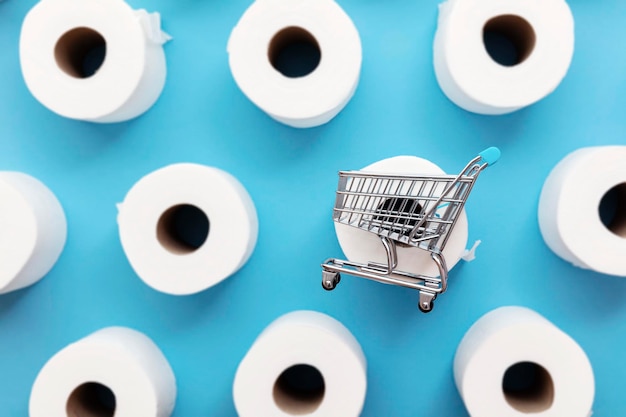 Roll of white toilet paper with a shopping cart on a blue background