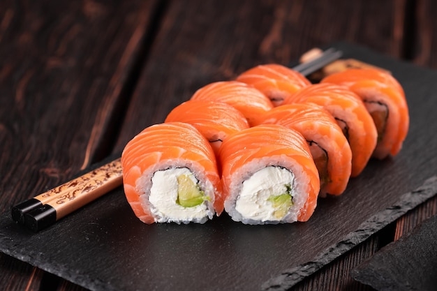 Roll with fish sushi with chopsticks asian food concept