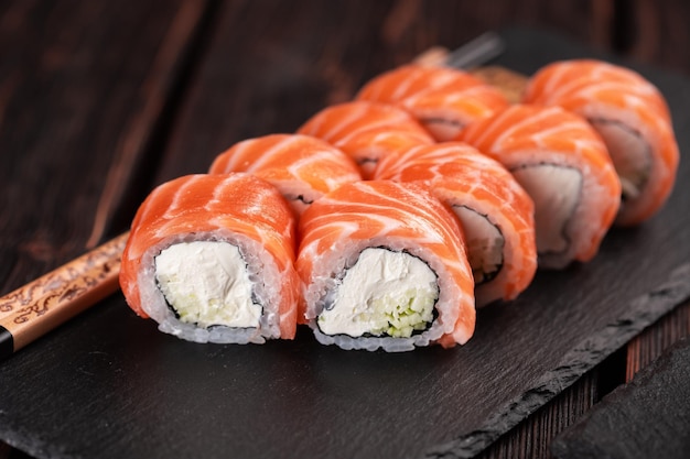 Roll with fish sushi with chopsticks asian food concept