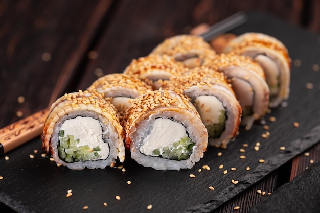 Roll with fish sushi with chopsticks asian food concept