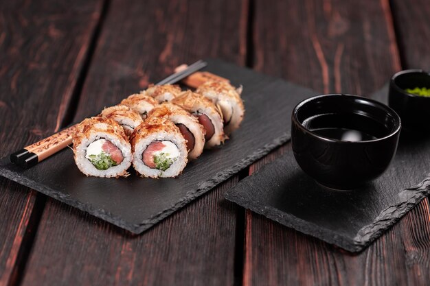 Roll with fish sushi with chopsticks asian food concept