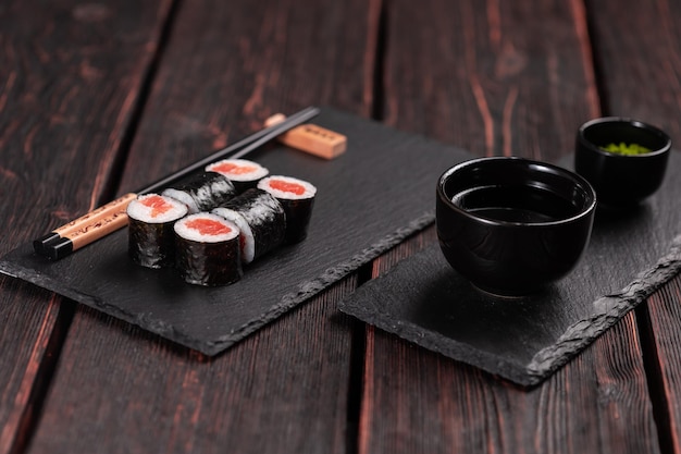 roll with fish sushi with chopsticks asian food concept