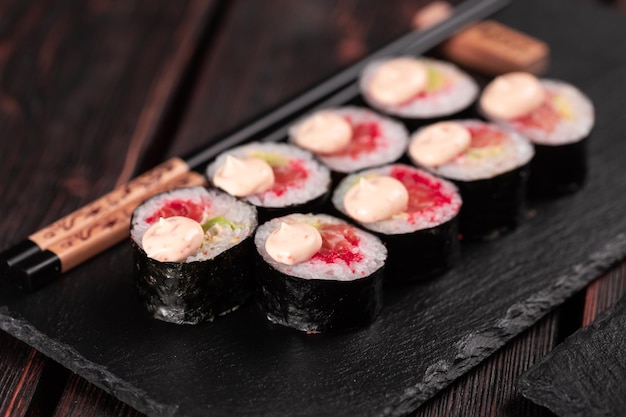 Roll with fish sushi with chopsticks asian food concept