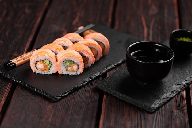 Roll with fish sushi with chopsticks asian food concept