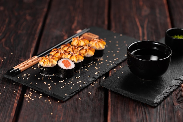 Roll with fish sushi with chopsticks asian food concept