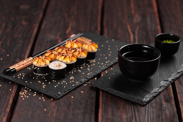 Photo roll with fish sushi with chopsticks asian food concept