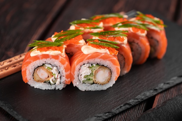 Roll with fish sushi with chopsticks asian food concept