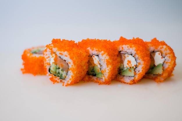 A roll with salmon and rice with tobiko caviar