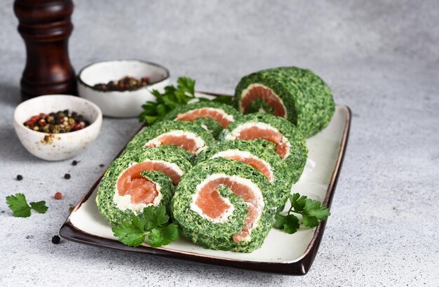 Roll with spinach and salmon. Snack with red fish and cheese and lemon.