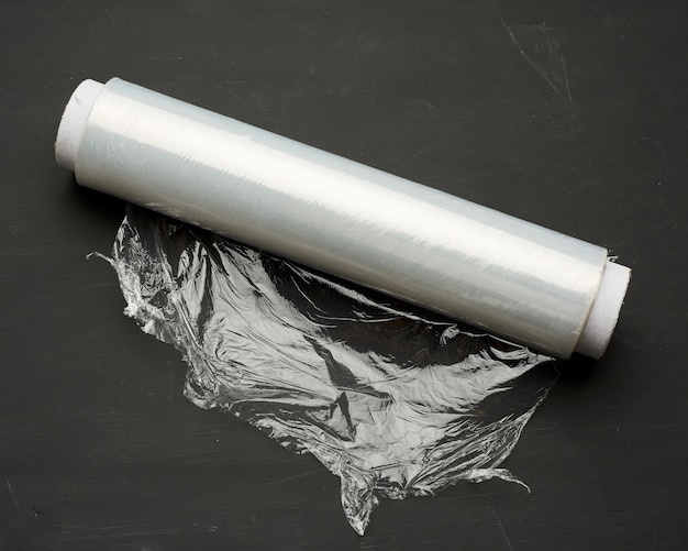 Roll of wound white transparent film for wrapping food, black background