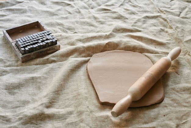 Rolled clay with a wooden rolling pin on the table