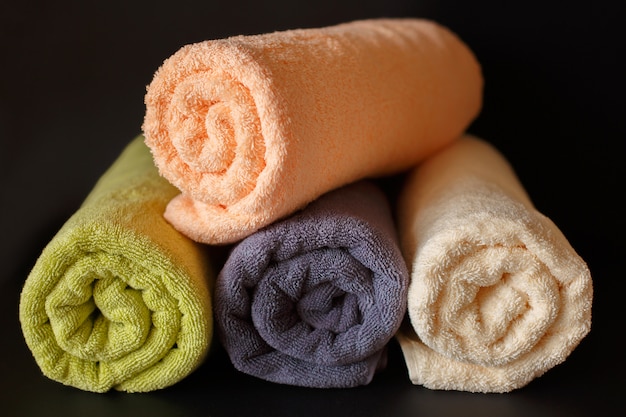 Rolled clean towels on black 