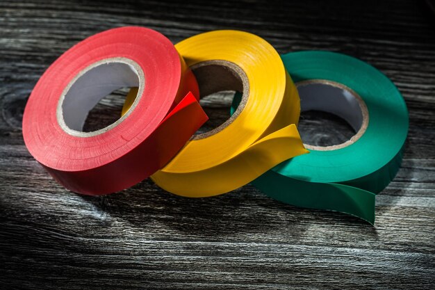 Photo rolled insulating tapes on wooden board