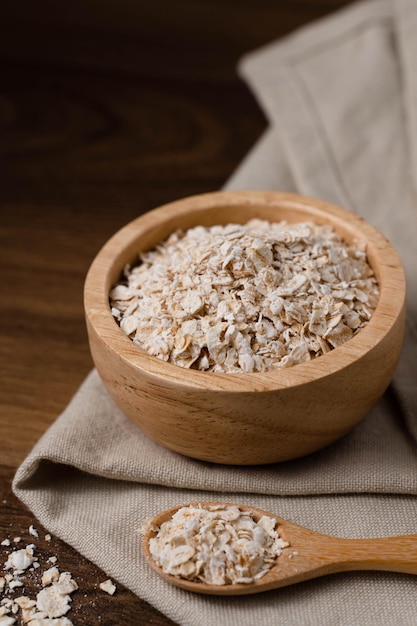 Rolled oats healthy breakfast cereals oatmeal in a bowl on a wooden table