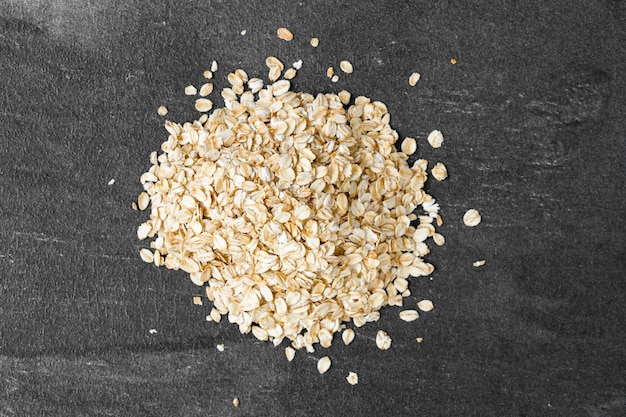 Rolled oats isolated on dark background