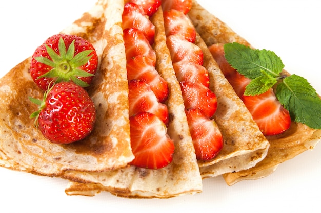 Rolled thin pancakes with strawberry and mint