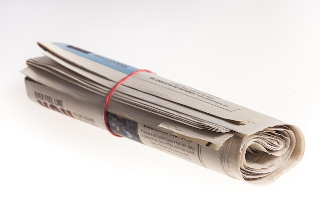 Photo rolled up newspapers close up on light background