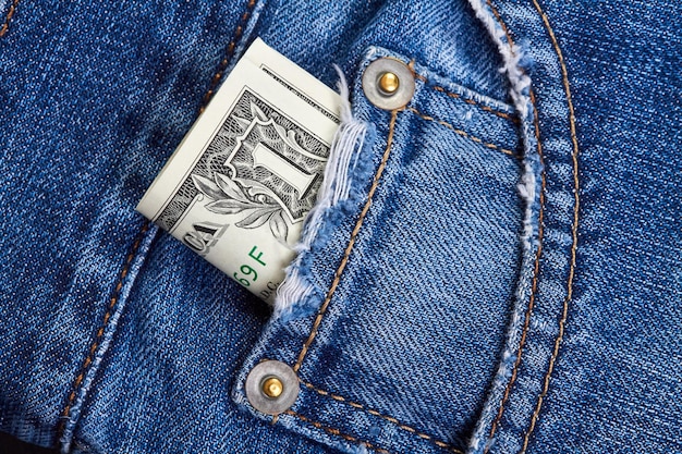 Photo rolled up one dollar bills in jeans pocket