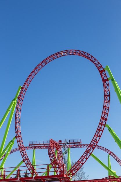 A roller coaster loop against the blue sky