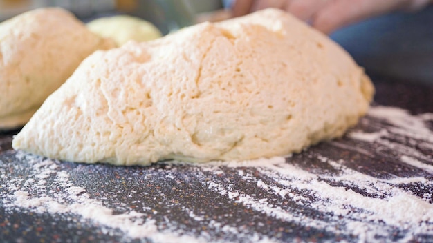 Rolling out pizza dough for individual small pizzas.