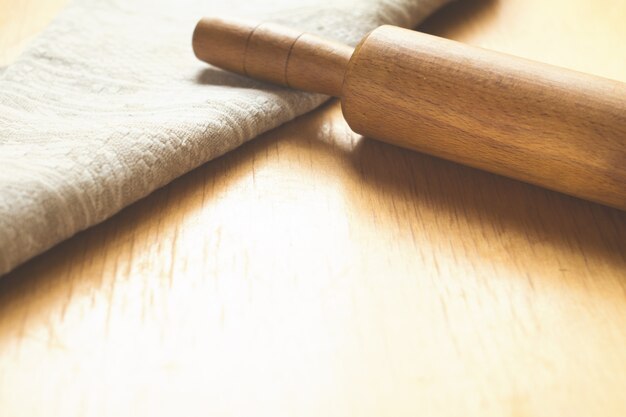 Rolling pin, towel and flour on the table