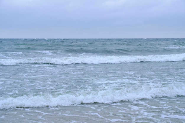 Rolling waves on sandy beach Baltic Sea