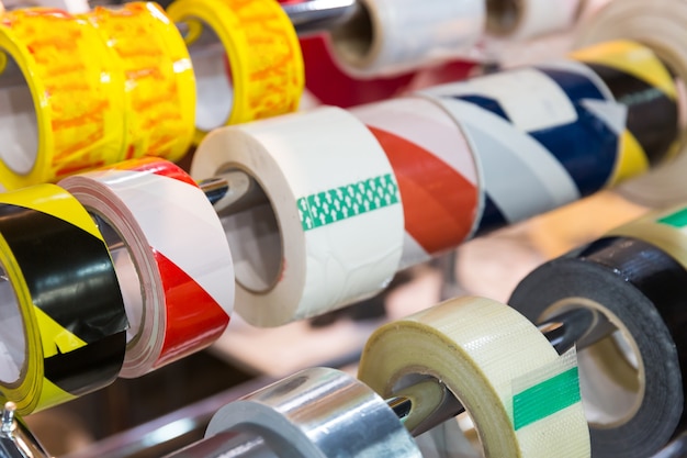 Rolls of different packing scotch tapes in the shop close up