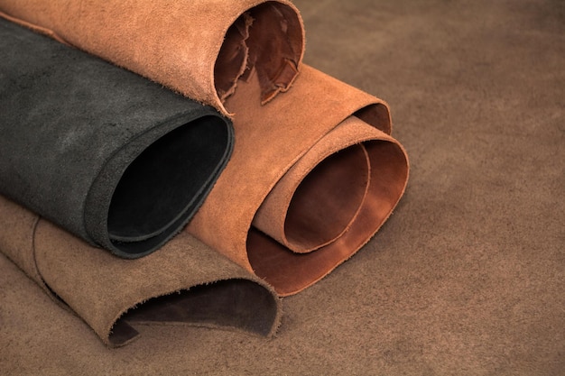 Rolls of natural brown and black leather Materials for leather craft