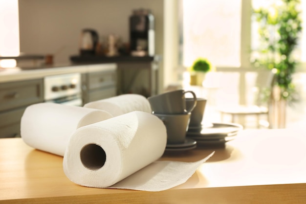 Rolls of paper towels and dishware on table indoors