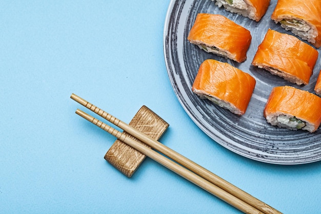 Rolls Philadelphia With Salmon Eel On Blue Background