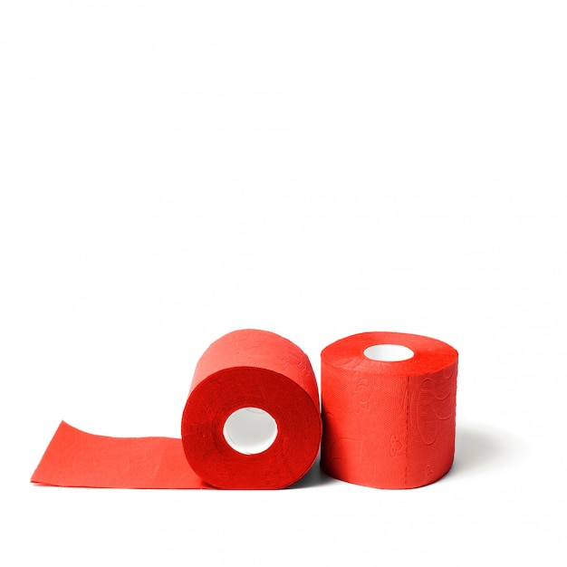 Rolls of red coral toilet paper isolated on white background.