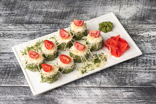 Rolls sushi with fish on a white wooden background