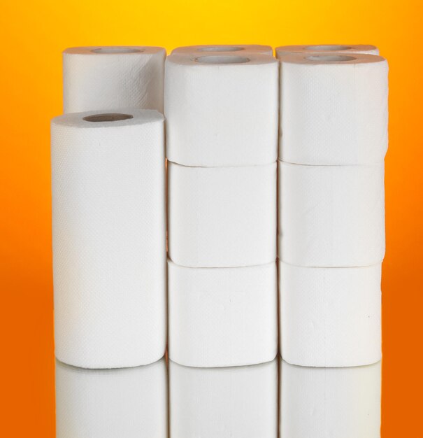 Photo rolls of toilet paper on orange background