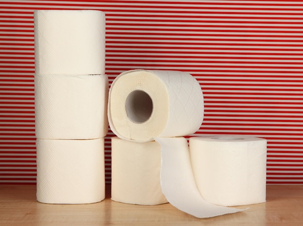 Rolls of toilet paper on striped red background