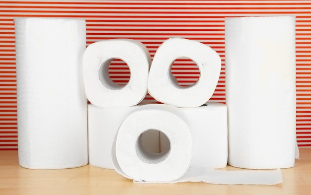 Rolls of toilet paper on striped red background