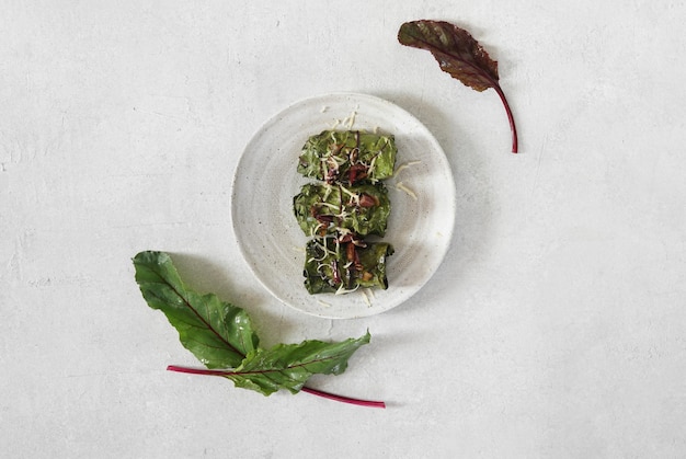 Rolls with beet leaves served on the plate A Vegetarian Cooking top view copy space