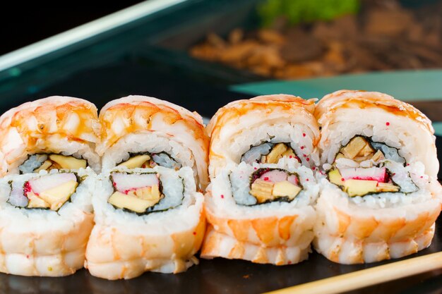 Rolls with shrimp, cheese, and eel, avocado and caviar, nori close-up.