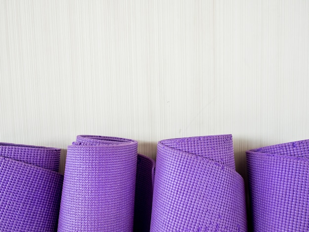 Photo rolls of yoga mats left in the yoga gym room.