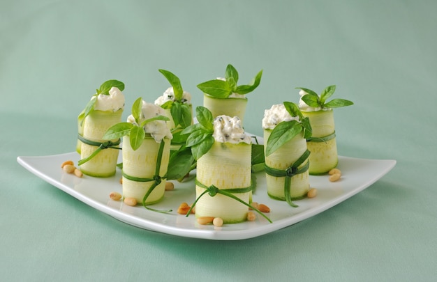 Rolls of zucchini stuffed with ricotta and basil and pine nuts