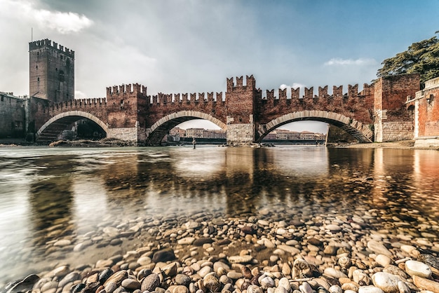 Roman arch bridge Ponte Pietra over Adige river in city Verona Italy