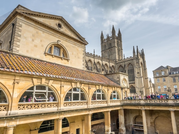 Roman Bath under cloudy sky and green colour water in Roman Bath England