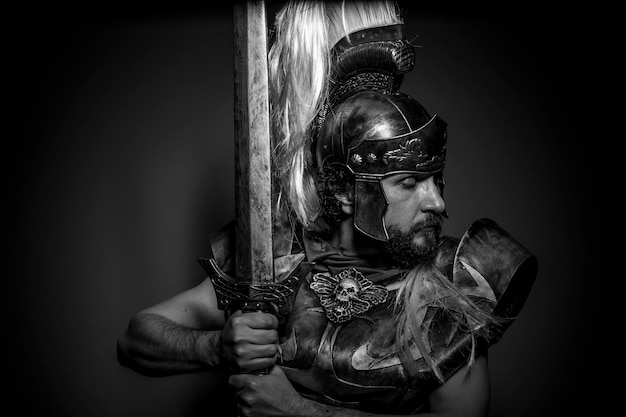 Roman centurion with armor and helmet with white chalk, steel\
sword and long red cape