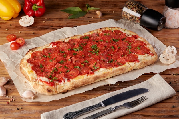 Roman pizza, variant of classic Italian pizza, wooden background