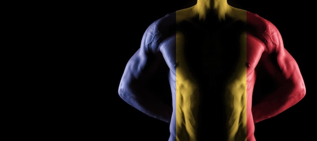 Romania flag on muscled male torso with abs, black background