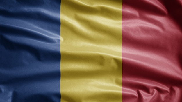 Romanian flag waving in the wind. Close up of Romania template blowing, soft and smooth silk. Cloth fabric texture ensign background.