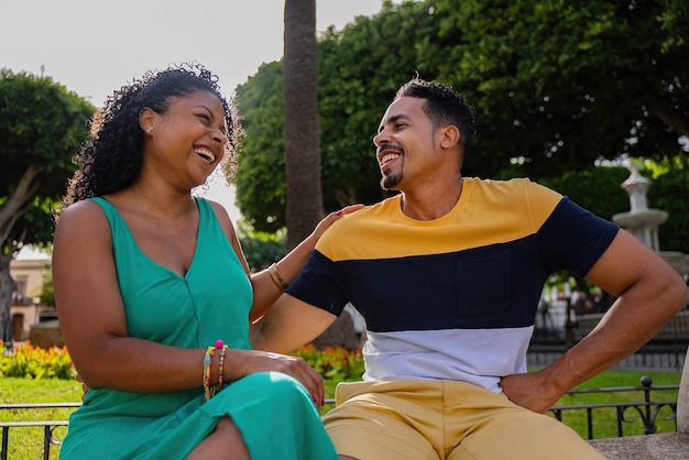 Romantic african american couple sitting on a bench