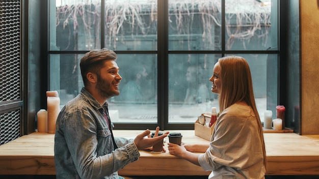 romantic atmoshere man and woman have a meeting in a modern cafe